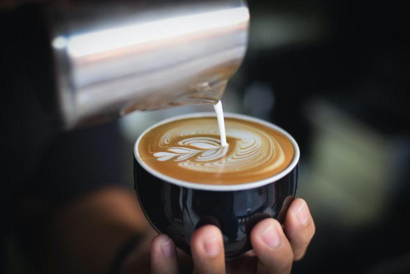 pouring milk forming a heart latte